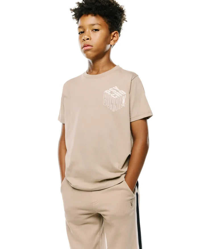 Kids Conan Back Graphic Tee in beige, with a white 3D-effect Psycho Bunny text graphic on the chest, classic fit, smooth jersey fabric.