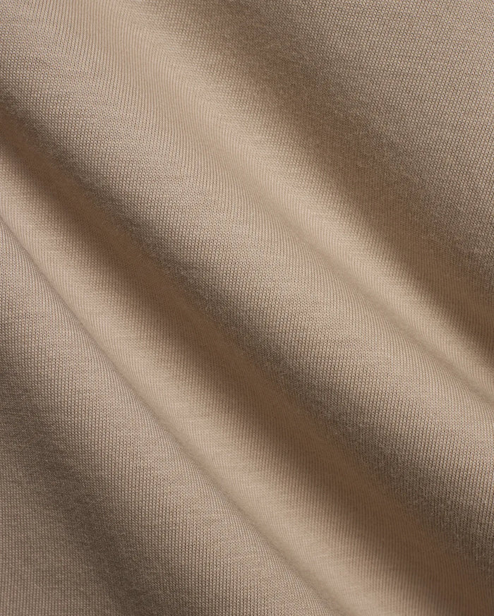 Kids Conan Back Graphic Tee in beige, crafted from soft jersey knit fabric with subtle texture, featuring a bold back graphic and signature Psycho Bunny branding.