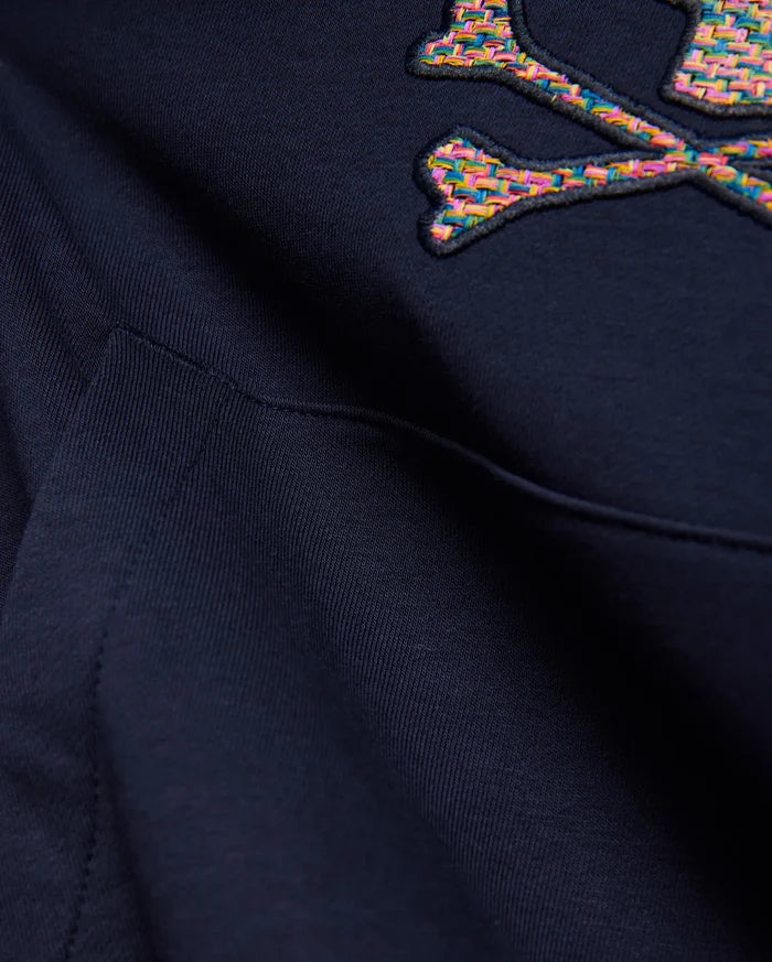 Kids Darcy Hoodie in deep navy blue, featuring a large, embroidered multicolored woven Psycho Bunny skull and crossbones logo and a front kangaroo pocket detail on soft knit fabric.