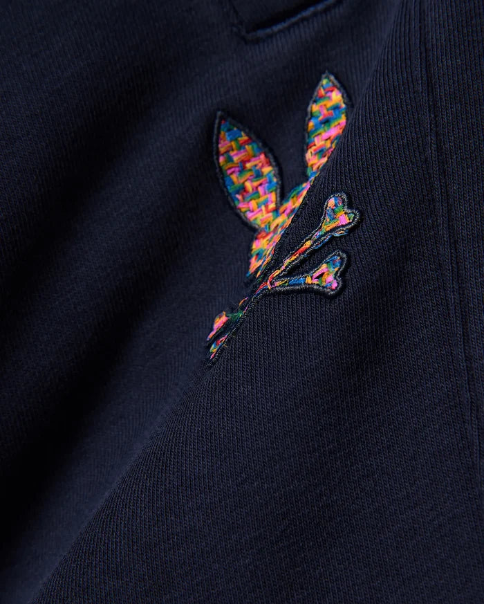 Kids Darcy Sweatpant in deep navy, crafted from soft jersey knit fabric, prominently featuring a medium-sized, intricately embroidered multicolor Psycho Bunny skull logo with a vibrant, woven texture.