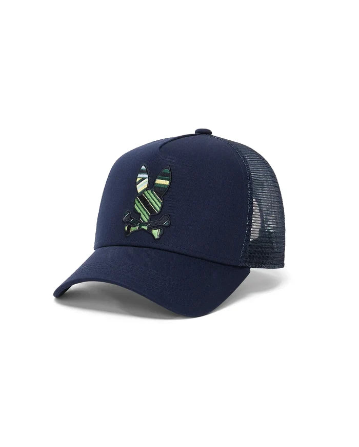 Kids Drew Trucker Cap in navy cotton twill with a mesh back, featuring a large, embroidered Psycho Bunny skull logo on the front with green, yellow, and white stripes.
