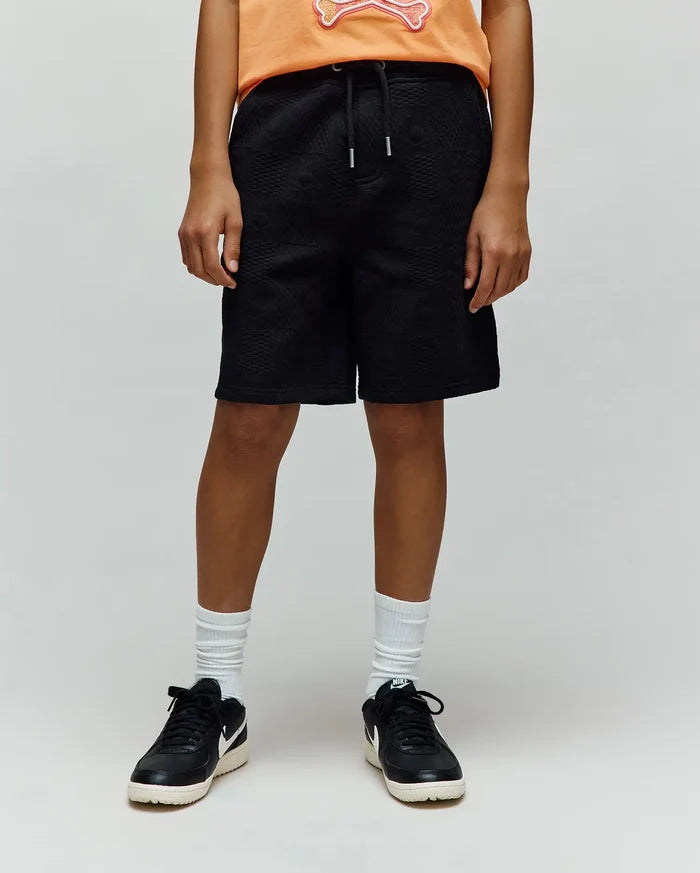 Kids Dustin Sweatshort, a premium black relaxed-fit sweatshort featuring a unique all-over quilted texture and an adjustable drawstring waist for refined streetwear style.