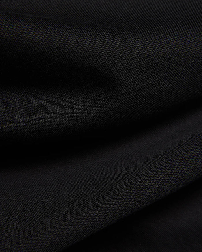Kids Frank Back Graphic Tee, a premium Psycho Bunny black jersey knit fabric with a refined, subtle diagonal ribbed texture, embodying sophisticated streetwear style.