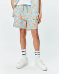 Kids Frank Swim Trunk in white with a vibrant blue and orange mosaic pattern, featuring repeated Psycho Bunny skull logos and a bright blue drawstring, in a relaxed fit.
