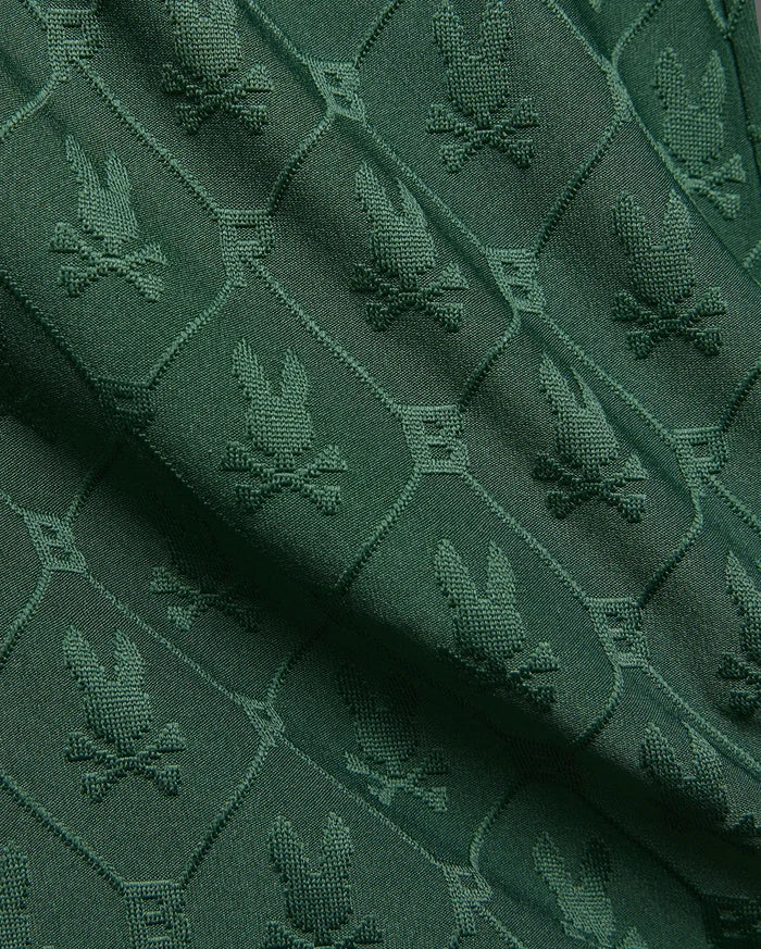 Kids Garry Jacquard Sweatshort in deep forest green, featuring an all-over textured jacquard knit pattern of the iconic Psycho Bunny skull logo within diamond shapes.