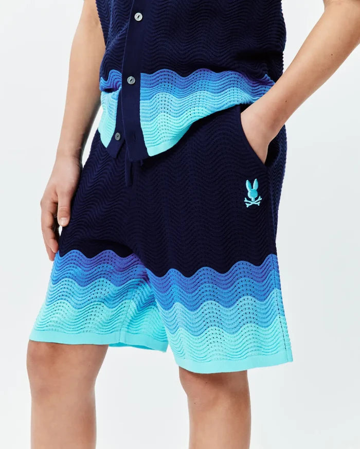 Kids Holden Knit Short in navy blue with a wavy knit texture, featuring an ombre design of royal, light, and turquoise blue bands, and a small embroidered turquoise Psycho Bunny skull logo.