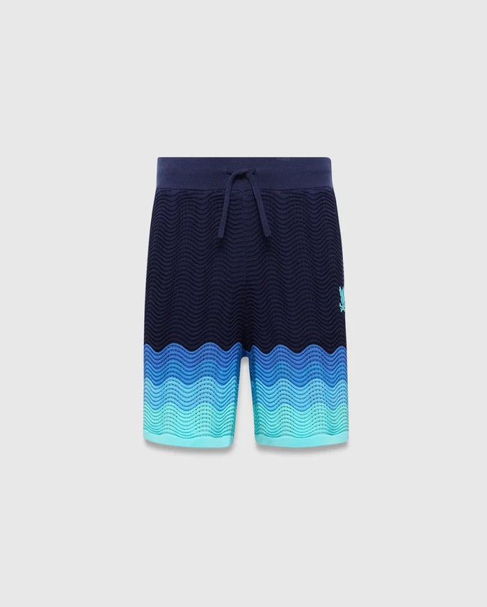 Kids Holden Knit Short in navy with a wavy knit texture, featuring a blue to teal gradient hem and a small embroidered Psycho Bunny skull logo on the right thigh.