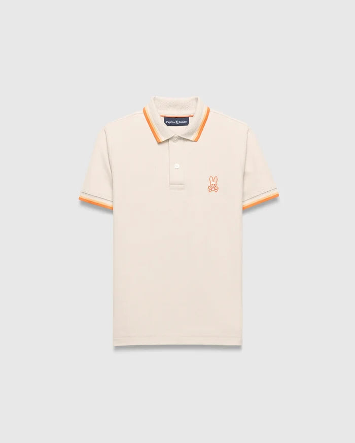 Kids Holden Pique Polo, a classic fit cream pique polo with orange striped ribbed collar and cuffs, featuring a small embroidered orange Psycho Bunny skull logo on the left chest.
