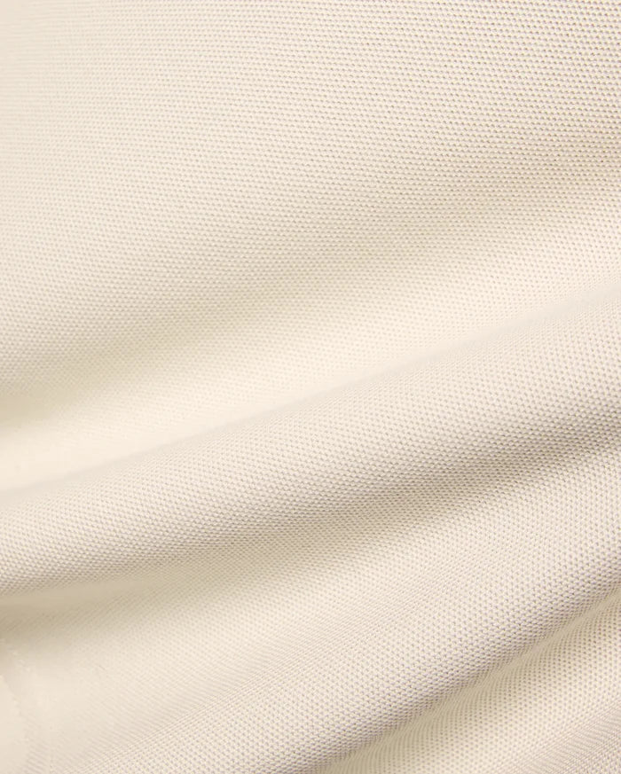 Kids Holden Pique Polo fabric swatch in a soft cream hue, showcasing the classic textured pique knit, perfect for premium menswear, refined streetwear, and comfortable, stylish apparel.