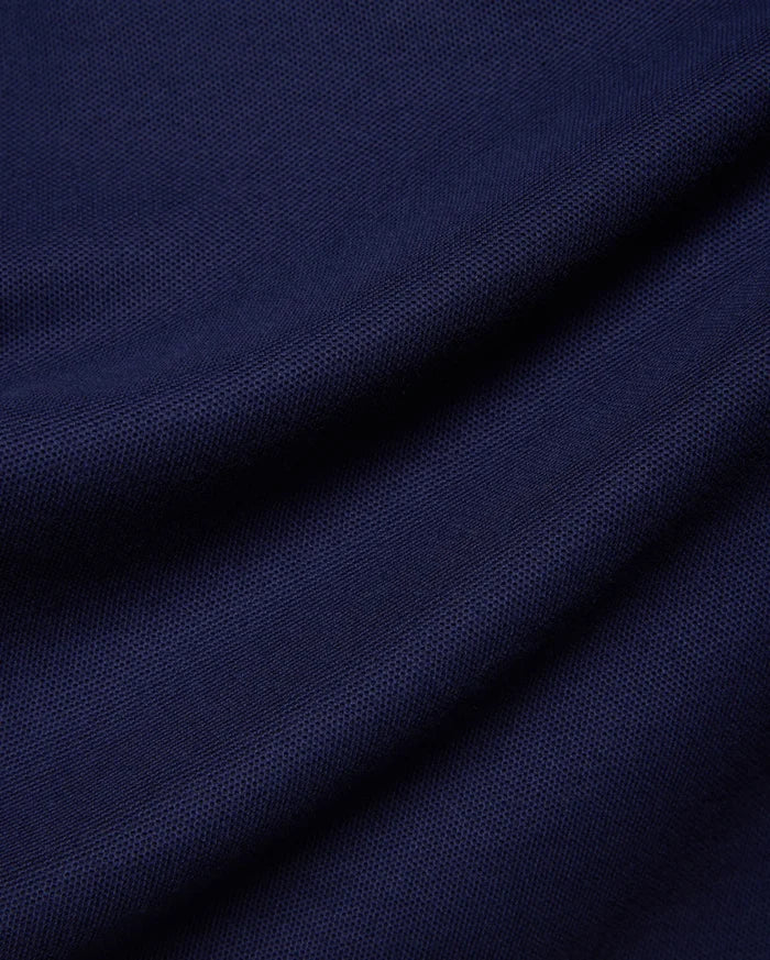 Kids Holden Pique Polo in rich navy blue, a classic fit polo crafted from breathable pique fabric, featuring the iconic embroidered Psycho Bunny skull logo on the left chest.