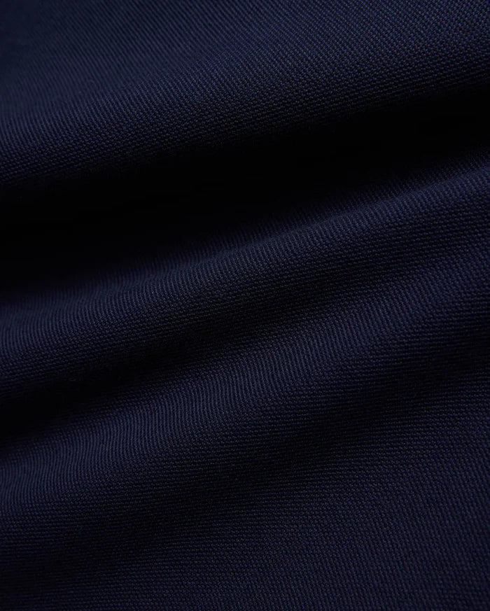 KIDS JAYDON PIQUE POLO in a deep, luxurious navy blue, showcasing the intricate, breathable texture of its premium pique knit fabric, a hallmark of Psycho Bunny's refined quality.