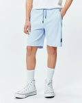 Kids Keith Short 3 1/2, light blue pique knit, relaxed fit with drawstring waist, side pockets, and a small embroidered navy Psycho Bunny skull logo on the left leg.