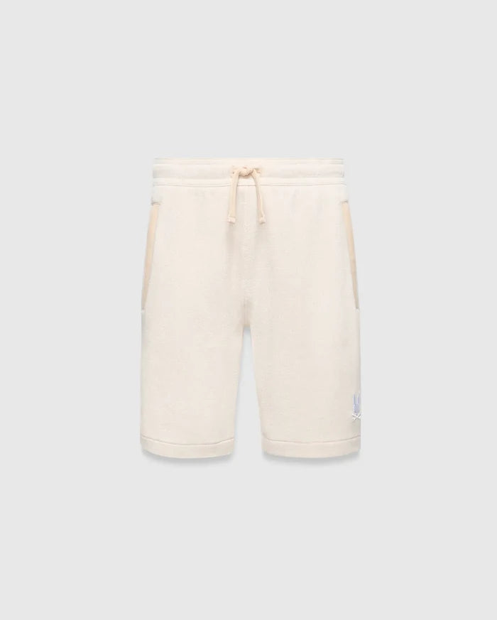Kids Keith Short 3 1/2, a cream textured knit relaxed fit short with drawstring waist, light beige pocket trim, and a small embroidered light blue Psycho Bunny skull logo on the lower left leg.