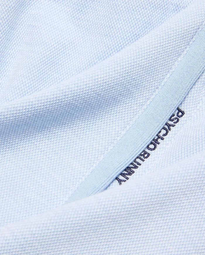 Light blue pique knit Kids Keith Short, showcasing premium streetwear with dark blue embroidered PSYCHO BUNNY text on a subtle lighter blue trim.