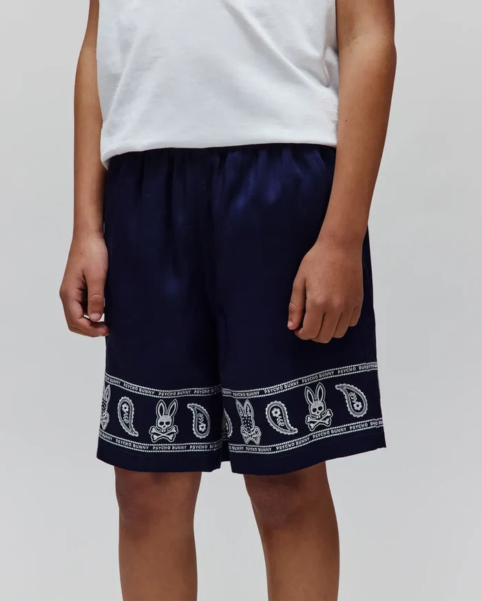 Kids Luke Tencel Short, navy blue with a white bandana-style print featuring Psycho Bunny skull logos, paisley motifs, and PSYCHO BUNNY text along the hem, in a relaxed fit.