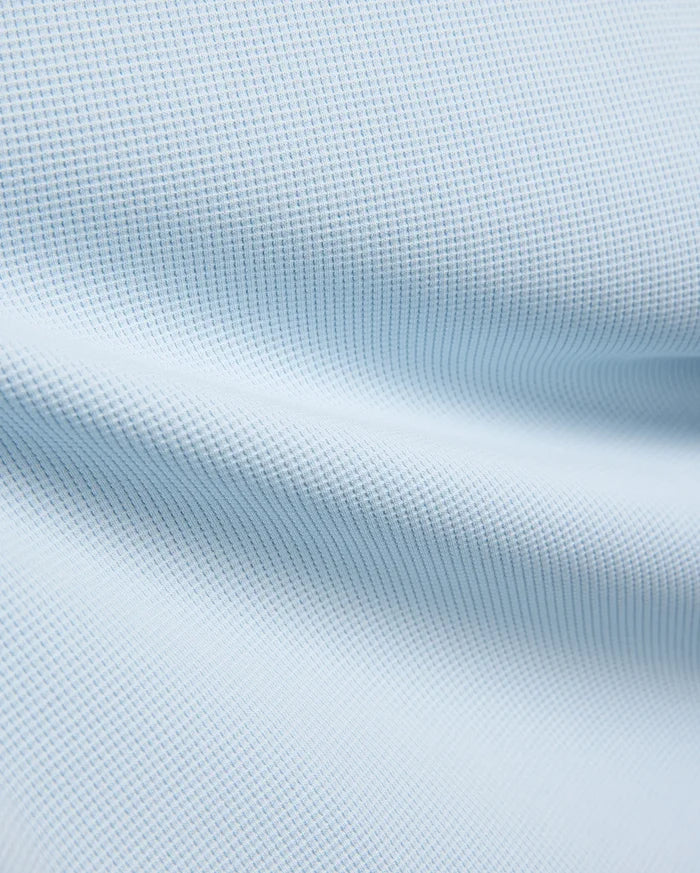Kids Maxton Waffle Tee fabric in a soft sky blue, showcasing its distinctive raised waffle knit texture with subtle folds, ideal for comfortable, refined streetwear.