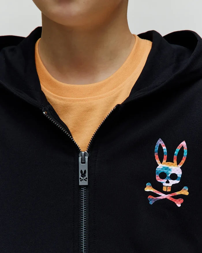 Kids Raphael French Terry Full Zip Hoodie in black, featuring a large, colorful tie-dye Psycho Bunny skull logo on the left chest and a branded zipper pull.