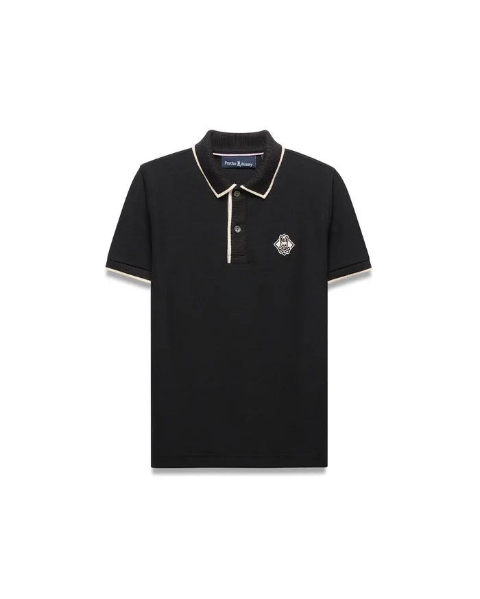 Kids Robin Pique Polo, black classic fit pique with cream piping on collar and sleeves, featuring an embroidered Psycho Bunny skull logo in a diamond on the left chest.