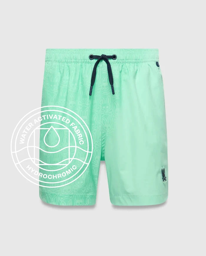 Kids Samos Hydrochromic Printed Swim Trunk in mint green, featuring a subtle hydrochromic bunny skull pattern that appears when wet, dark blue drawstring, and small embroidered Psycho Bunny logo on the left leg.
