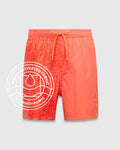 Kids Samos Hydrochromic Printed Swim Trunk in vibrant coral, featuring a water-activated all-over Psycho Bunny skull pattern on the left, solid right leg, and small embroidered bunny logo.