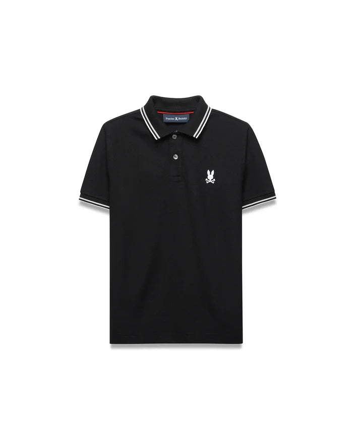 Kids Stan Pique Polo. Black classic fit pique polo with white double-striped collar and cuffs, red neck tape, and small white embroidered Psycho Bunny skull logo on left chest.