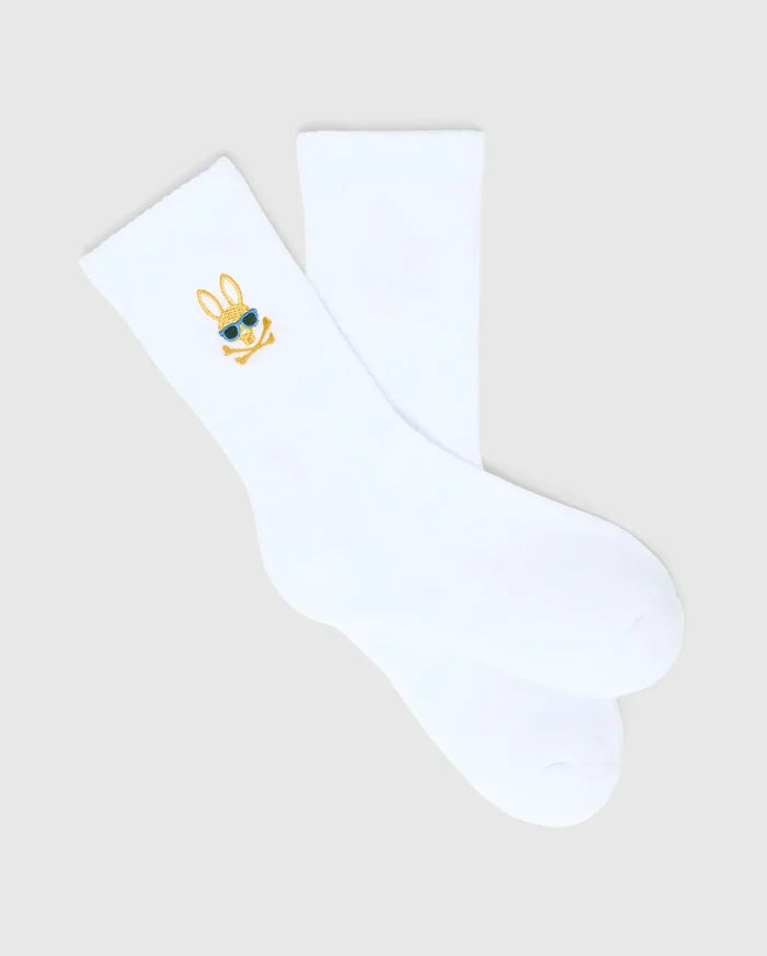 Kids Sunny 3 Pack Sport Socks: White smooth knit sport socks featuring a small, embroidered gold and blue Psycho Bunny skull logo with sunglasses on the ankle cuff.