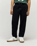 Kids Tate Chenille Sweatpant in black french terry, featuring a relaxed fit, drawstring waist, and a white chenille Psycho Bunny skull logo on the right thigh.