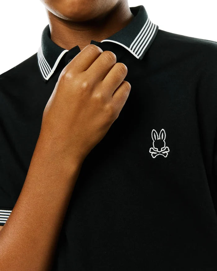 Kids Timmy Pique Polo, a black classic fit pique polo shirt with a ribbed collar and cuffs featuring crisp white stripes, accented by a small, embroidered white Psycho Bunny skull logo on the left chest.