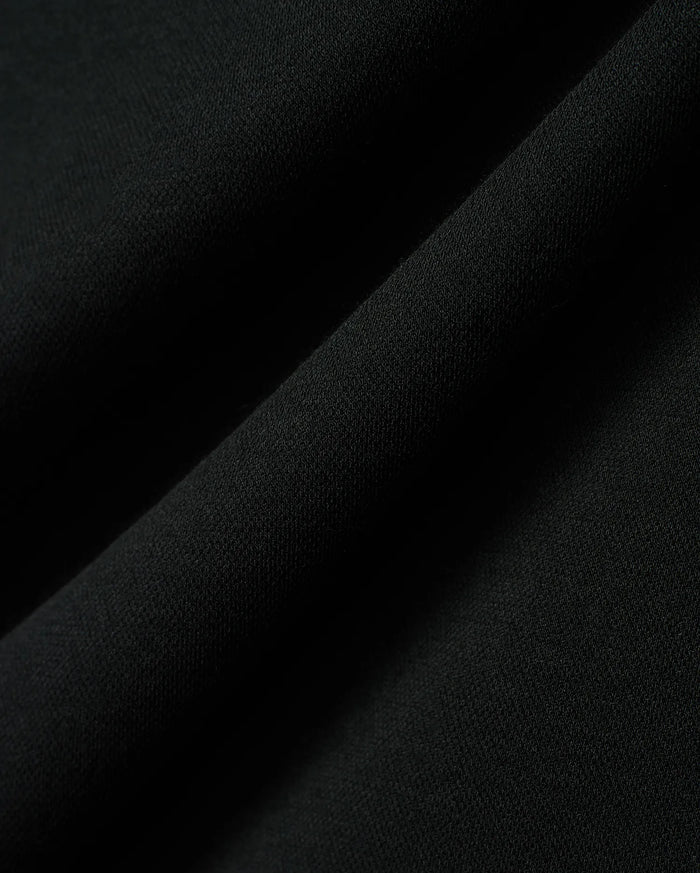 Kids Timmy Pique Polo in classic black, featuring a premium, finely textured pique knit fabric with soft, flowing folds, embodying Psycho Bunny's signature style.