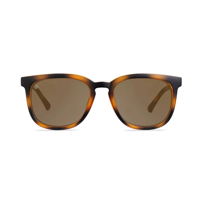 Sunglasses with tortoiseshell frame and brown lenses on a white background