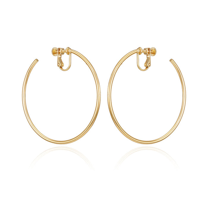 A pair of Vince Camuto Large Open Hoop Clip On Earrings, featuring trendy gold hoops with hinged clip-on backs, perfect for daily wear and displayed against a white background.