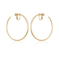 A pair of Vince Camuto Large Open Hoop Clip On Earrings, featuring trendy gold hoops with hinged clip-on backs, perfect for daily wear and displayed against a white background.