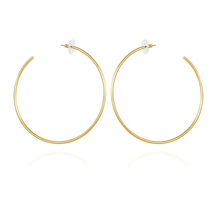 Large Open Hoop Earrings by Vince Camuto feature thin gold hoops with straight posts and clear, round backs, shown on a white background.