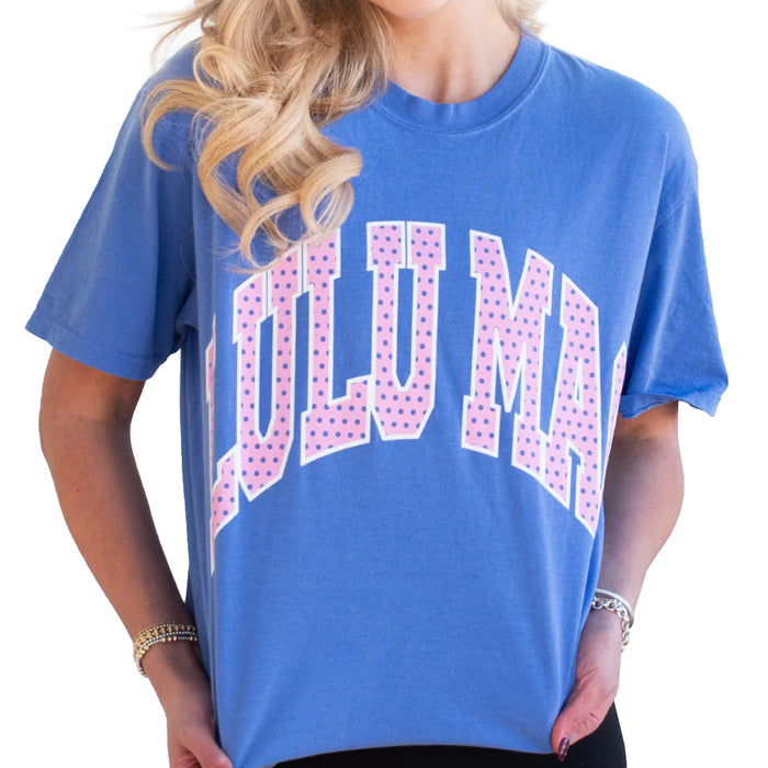 Model wearing Lulu Mac flo blue short sleeve t-shirt with large pink polka dot “LULU MAC” graphic across the chest.