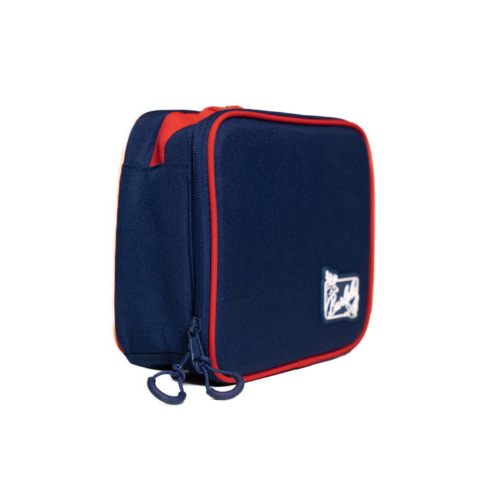 Burlebo lunchbox in patriotic colorblock shown from a back side angle with dual navy zipper pulls, red handle, and contrasting trim.