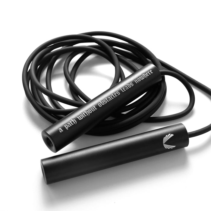 flatlay of Mantra Jump Rope in black with coiled cord, overhead view