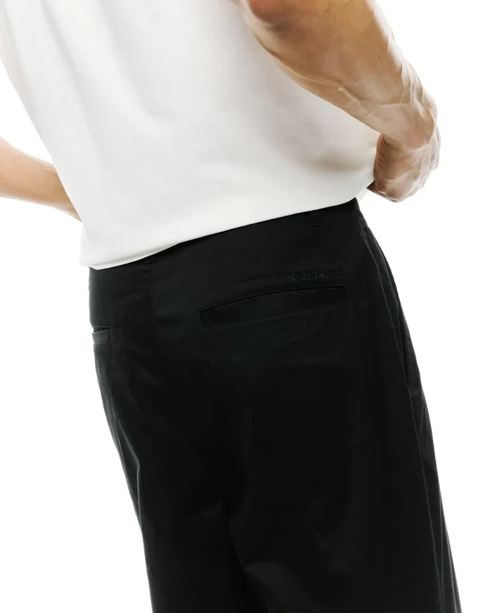 Mens Aidan Chino Pant, a premium black cotton twill with a classic fit and subtle tonal embroidered Psycho Bunny text above the back right pocket.