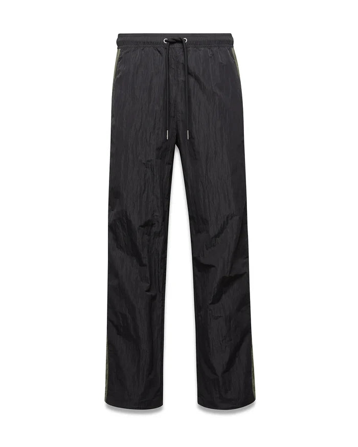 Mens Alder Nylon Colorblock Pant in black crinkled nylon, offering a relaxed fit with a drawstring waist and distinct olive green side stripes.
