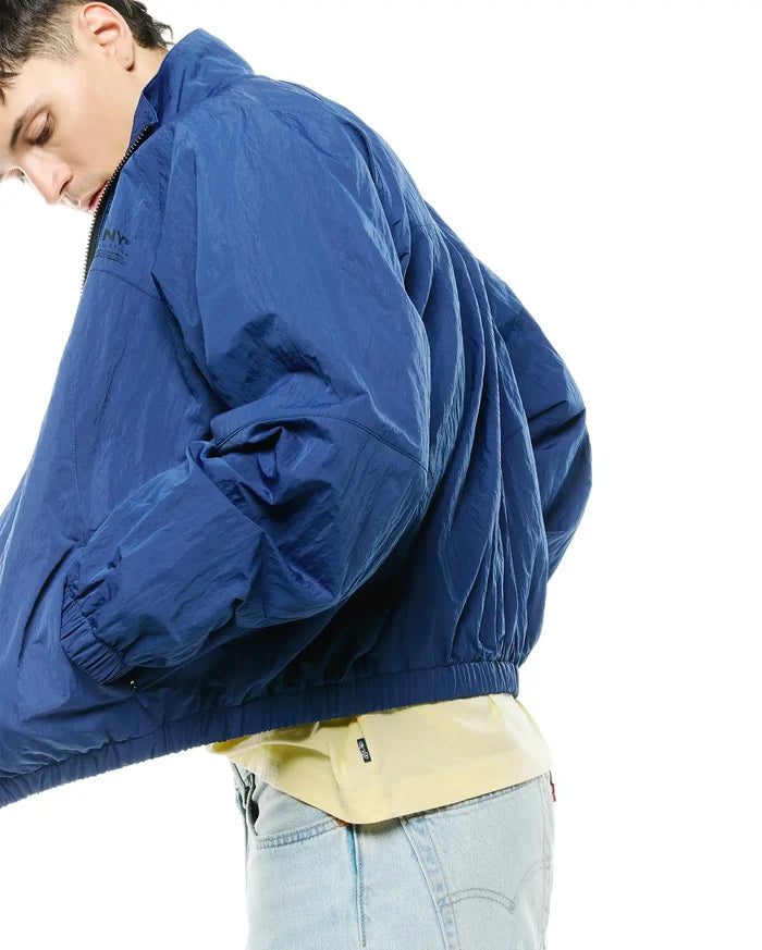 Mens Alder Nylon Jacket in royal blue, featuring a crinkled nylon texture, full zip, stand-up collar, elasticated cuffs and hem, and a subtle NY® Reception graphic on the left chest.