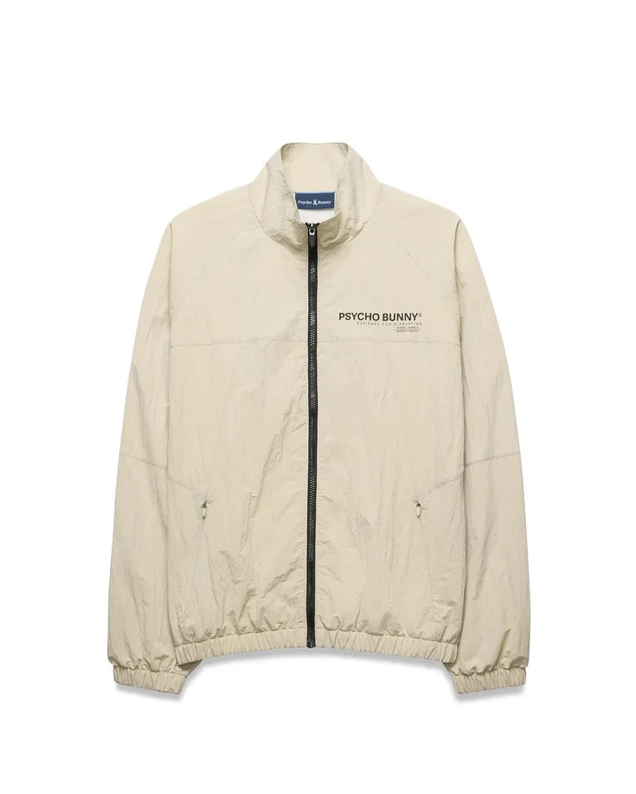 Light beige Mens Alder Nylon Jacket, a classic fit crinkled nylon jacket with full black zip, stand collar, zippered side pockets, elastic cuffs/hem, and a black Psycho Bunny chest logo.