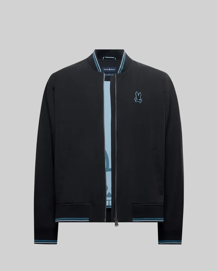 Mens Aldrin Bomber jacket in black, featuring a classic fit, smooth fabric, light blue and white striped ribbed collar, cuffs, and hem, with a small embroidered light blue Psycho Bunny skull logo on the left chest.