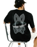 Mens Alex Relaxed Back Graphic Tee in black jersey knit, featuring a large white and grey dotted Psycho Bunny skull graphic on the back and vertical Psycho Bunny text along the shoulders.