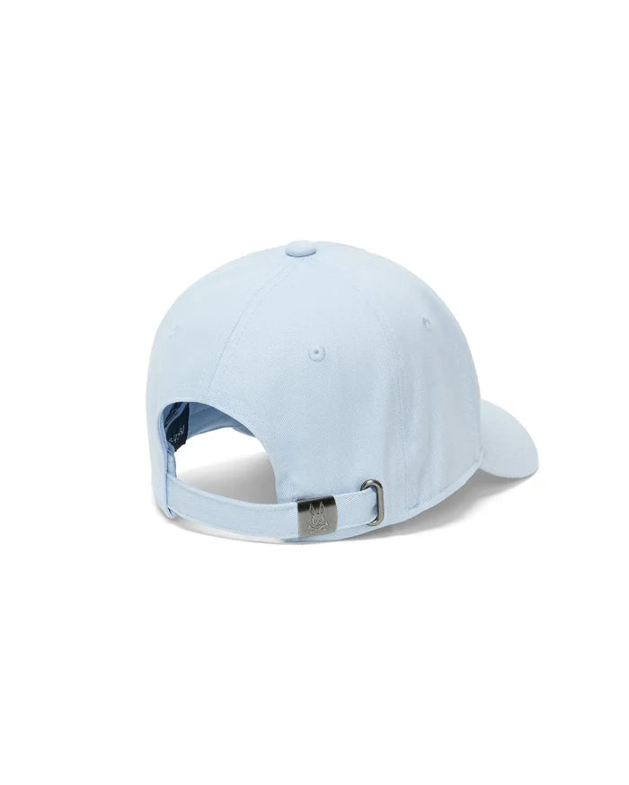 Mens Ambrose Baseball Cap, a classic fit in light blue cotton twill, featuring an adjustable strap with a gunmetal buckle engraved with the iconic Psycho Bunny skull logo.