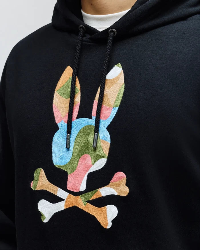 MENS ARA HOODIE, a black classic fit French terry hoodie with a large, central, multi-colored embroidered Psycho Bunny skull logo in blue, green, pink, orange, and white, featuring branded drawstring tips.
