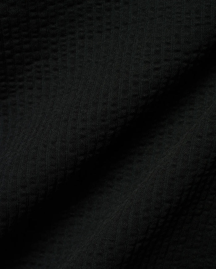Mens Arlen Relaxed Seersucker Tee, a premium black tee crafted from a distinctive puckered seersucker fabric, offering a relaxed fit and refined streetwear aesthetic.