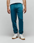 Mens Barry Joggers in deep teal, featuring a relaxed fit, soft jersey fabric, drawstring waist, ribbed cuffs, and a small tonal embroidered Psycho Bunny skull logo on the left thigh.