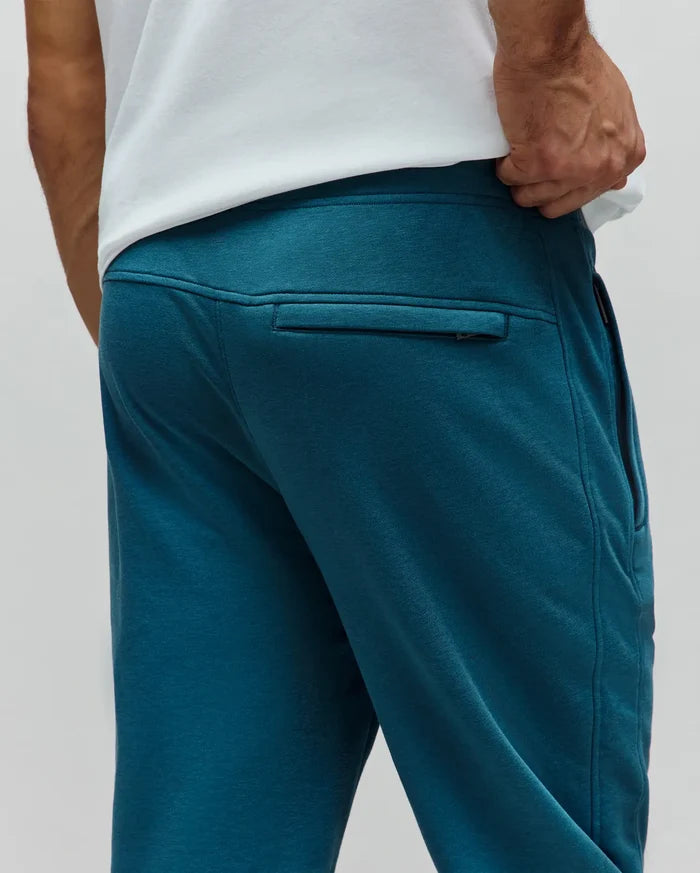 Mens Barry Joggers in deep teal, a relaxed fit, soft french terry knit, featuring a subtle rear zippered pocket and practical side pockets for refined streetwear style.