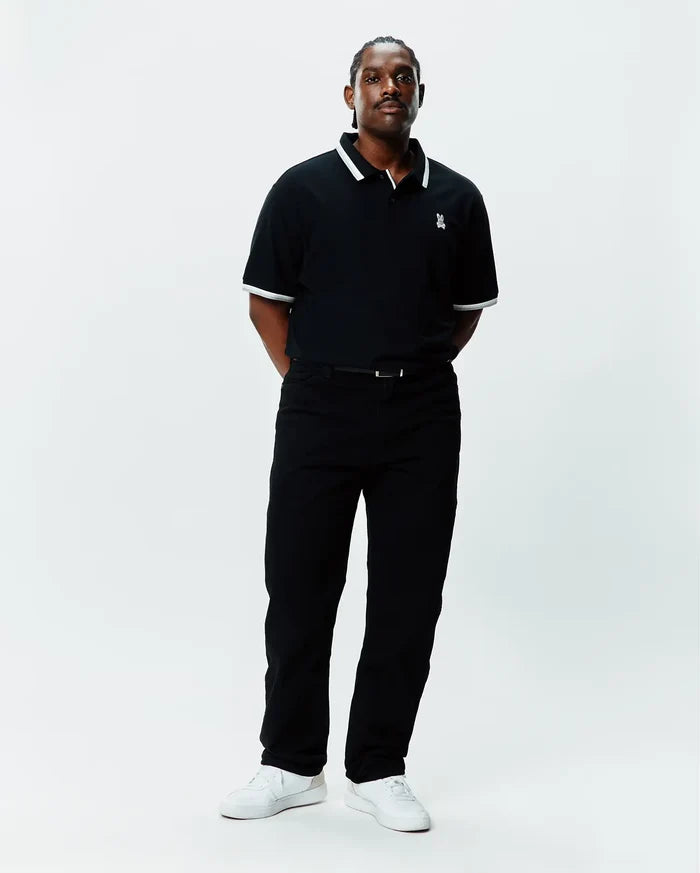 Mens Big And Tall Holden Pique Polo in black pique with white tipping on the collar and cuffs, featuring a small embroidered white Psycho Bunny skull logo on the left chest.