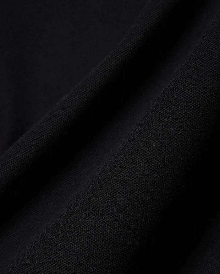 Mens Big And Tall Holden Pique Polo in rich, deep black, showcasing its premium, finely textured pique knit fabric with subtle, elegant folds, reflecting refined quality.