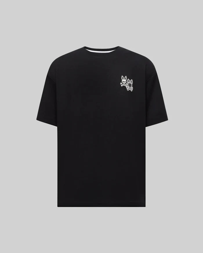 Mens Big And Tall Luke Back Graphic Tee, black relaxed fit jersey knit t-shirt with a white dual Psycho Bunny skull graphic print on the left chest, featuring crossbones and a bandana pattern.